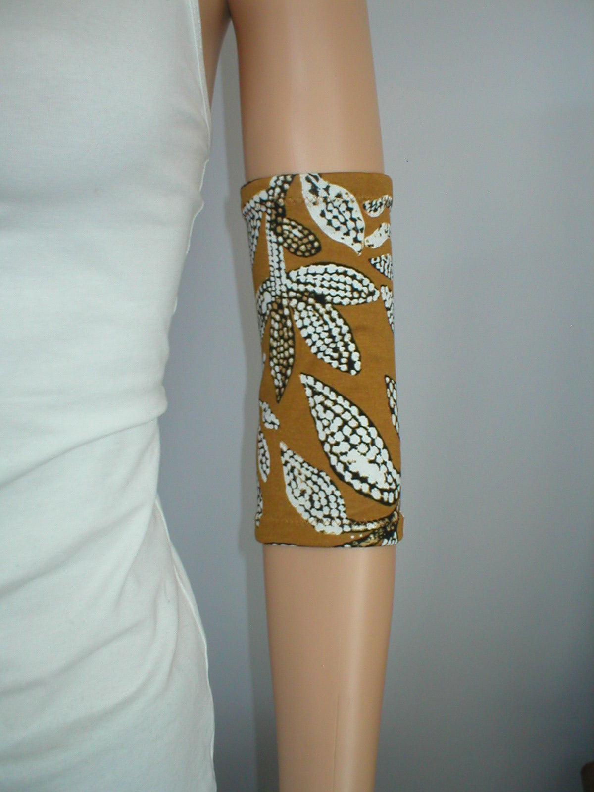 Premium patterned medium picc line covers -Ochre dotty leaves